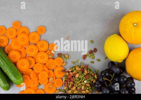 fresh vegetables, fruits and nuts on a gray background, top view of the food. Stock Photo