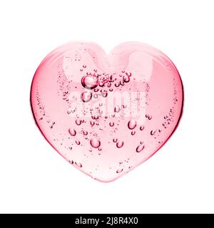Pink serum gel, heart shape puddle isolated on white backdrop, top view. Squeezed transparent care gel with bubbles close up, macro isolated on white