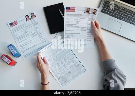Top-down view shot of unrecognizable woman working in US embassy working with travel visa applications Stock Photo