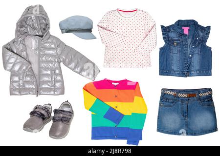 Collage set of clothes for a little girl isolated on a white background. The collection of a jeans vest and skirt, a sweater in a rainbow design, shir Stock Photo