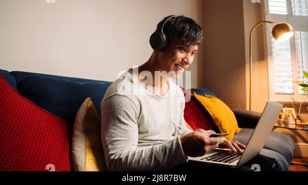 Young Asian man making credit card payment Stock Photo