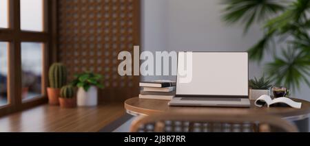 Coffee shop seating area in a comfortable and modern interior design with laptop white screen mockup, book and stuff on wood table. 3d rendering, 3d i Stock Photo