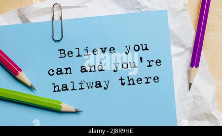 Believe you can and you're halfway there text written on a paper with pencils in office Stock Photo