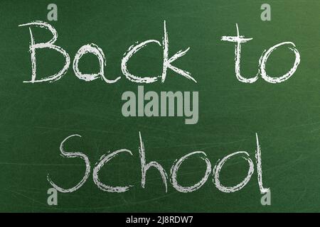 Back to school text on blackboard at school class. Placard with a hand drawn text Stock Photo