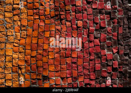 Mosaic of small red, yellow, brown, orange, bright pebbles. Vintage background. Stock Photo