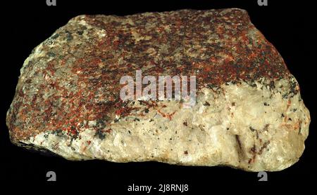 Zincite and franklinite. The red in this sample is zincite, ZnO