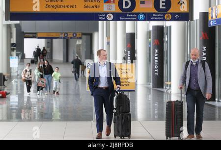 Calgary, Alberta, Canada - May 17 2022: Travelers at with luggage Calgary's International Airport. Stock Photo