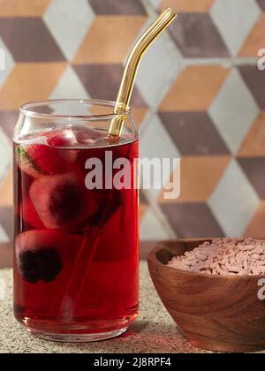 A glass of iced fruit tea made from instant tea granules Stock Photo
