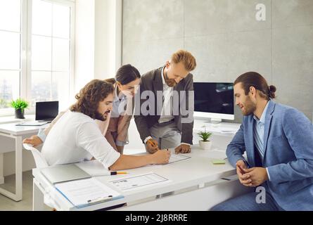 Diverse employees develop business project in office Stock Photo