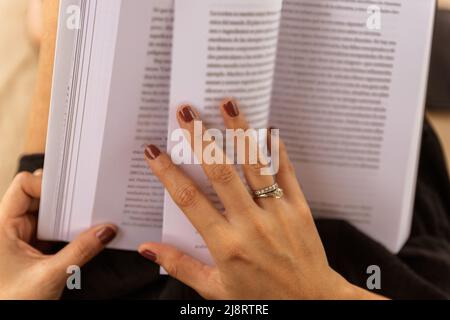 close up of a woman with a book in her hands Stock Photo