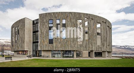 Akureyri, Iceland, April 29, 2022: view of the Hof cultural and conference center with the harbour fjord and mountains in the background Stock Photo