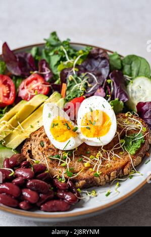 Medium boiled eggs with sasld, healthy breakfast Stock Photo