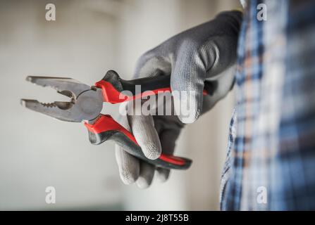 Construction Worker with Pliers in His Hand Close Up Industrial Theme Stock Photo