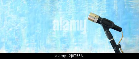 Podcasting and sound recording concept, vintage recording microphone on grungy blue background, negative space technique,panoramic Stock Photo