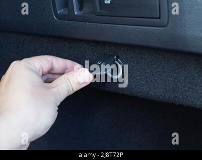 12 volt electrical outlet in the trunk of a car, close-up. Technology Stock Photo
