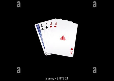 Four aces, four of a kind poker hand with one overturned card isolated on black background Stock Photo