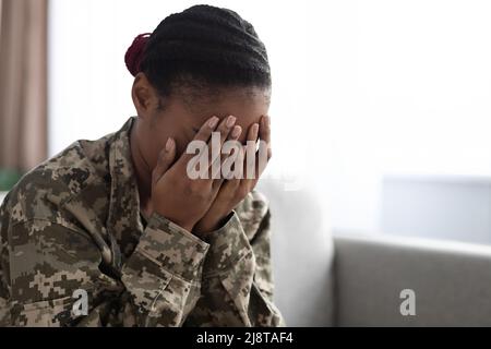 Depression Concept. Upset African American Soldier Lady Covering Face With Hands Stock Photo
