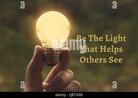 Motivational and Inspirational quote - Be the light that helps others see. With light bulb in vintage color background. Motivational concept Stock Photo