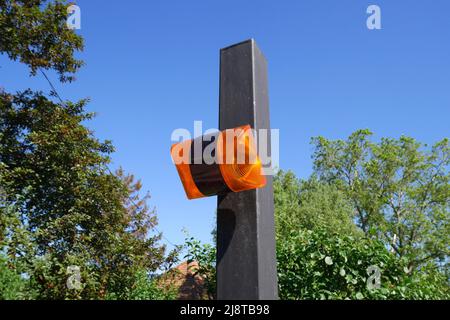 Orange flashing light for remote controlled gate opening system, Hungary Stock Photo