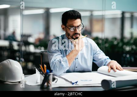 Serious busy smart handsome millennial middle eastern man engineer with beard in glasses Stock Photo