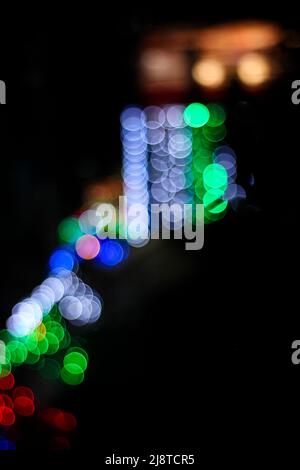 The bokeh lights on a dark background. Stock Photo