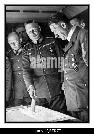 HITLER BATTLE PLANS STRATEGY 1940s WW2 Alfred Jodl (left) with Field Marshal Wilhelm Keitel and Adolf Hitler at the Wolf’s Lair, looking and discussing battle plans strategies and maps Nazi Germany Second World War World War II The Wolf's Lair (German: Wolfsschanze; Polish: Wilczy Szaniec) served as Adolf Hitler's first Eastern Front military headquarters in World War II. Stock Photo