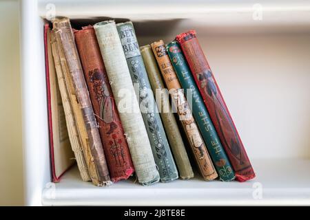 Old children's books on a shelf, early twentieth century Stock Photo