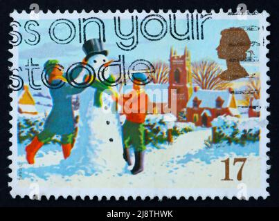 GREAT BRITAIN - CIRCA 1990: a stamp printed in the Great Britain shows Children’s in play and snowman, Christmas, circa 1990 Stock Photo