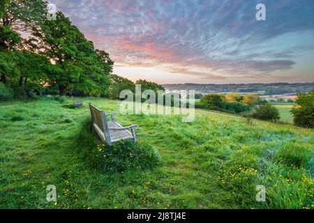 Wooden bench looking over High Weald landscape at sunrise in spring, Burwash, East Sussex, England, United Kingdom, Europe Stock Photo