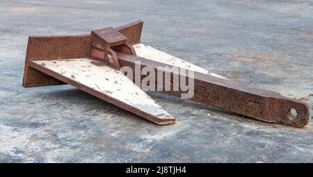 Aged rustic heavy industrial metal object on the ground Stock Photo