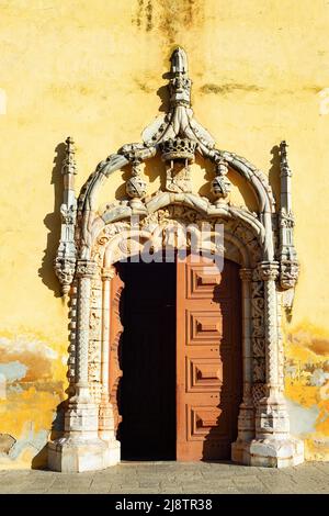 Historical building entrance door raditional decoration and shabby wall in sunlight, Portugal Stock Photo