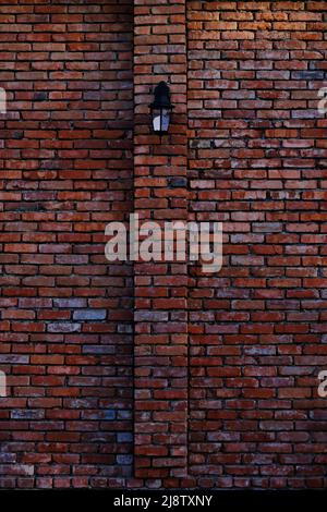 Street lamp on red, old brick wall Stock Photo