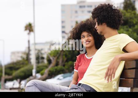 Happy young african american afro couple chatting while spending time together in city Stock Photo