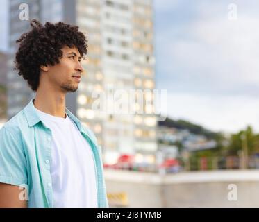 Thoughtful young afro african american man looking away in city, copy space Stock Photo