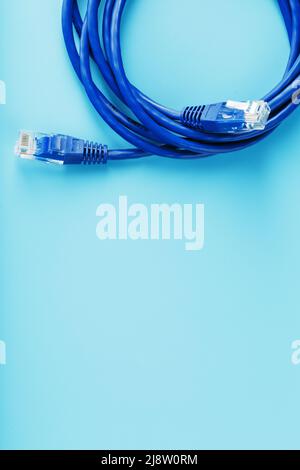 Blue UTP Internet Cable - Isolated on a blue background Ethernet Cord Stock Photo
