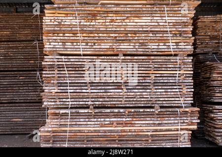 stack of planks, untreated birch planks, close-up with a blurred background. Stock Photo