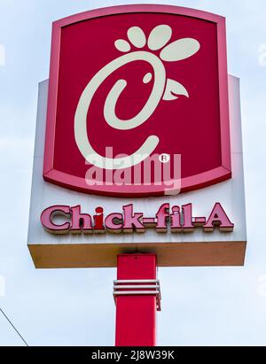 Outdoor Chick-fil-A free standing brand and logo street advertising in red and white in soft, early morning light in south Charlotte, North Carolina. Stock Photo