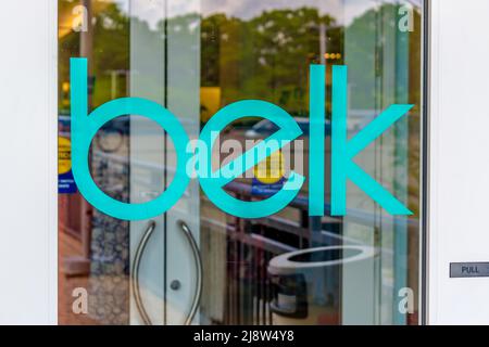 Exterior glass window 'Belk' outdoor brand and logo signage on entrance doors in bright letters with reflections in soft daylight at Southpark Mall. Stock Photo