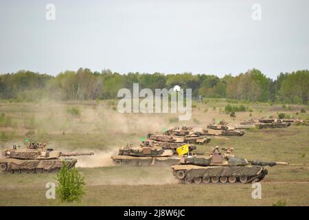 Drawsko Pomorskie, Poland. 17th May, 2022. A U.S. Army M1A2 Abrams main battle tanks assigned to 1st Battalion, 68th Armor Regiment, 3rd Armored Brigade Combat Team, 4th Infantry Division, maneuver during Defender Europe 22 multinational training exercise at Drawsko Pomorskie Training Area, May 17, 2022 in Drawsko Pomorskie, Poland. Credit: Capt. Tobias Cukale/U.S Army/Alamy Live News Stock Photo