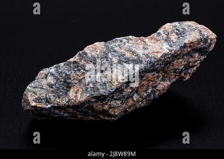 stone used in paving or paving, called granite or crushed stone, isolated from black background, copyspace Stock Photo