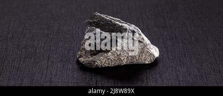 stone used in paving or paving, called granite or crushed stone, isolated from black background, copyspace Stock Photo