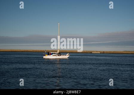 Sailing boat in the sea against the backdrop of mountains . ship sailing at sea.. Stock Photo