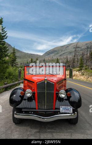 Glacier National Park, United States: July 26, 2021: Red Jammer Parked At Wild Goose Island Overlook In Glacier Stock Photo