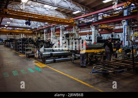 The process of assembling agricultural machines in the factory workshop. Stock Photo