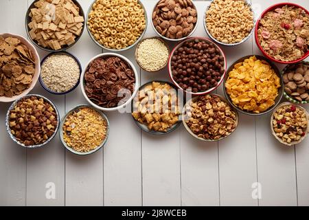 Assortment of different kinds cereals placed in ceramic bowls on table Stock Photo