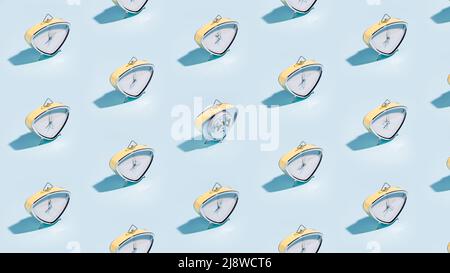 Many vintage alarm clocks pattern on blue background Stock Photo