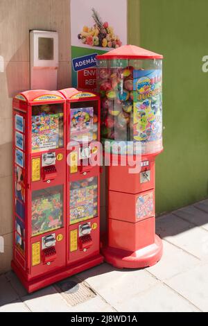 2022. Valencia, Spain. Close-up of some gum and toy vending machines in a downtown street of a city