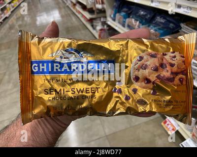 Augusta, Ga USA - 04 15 22: Hand holding Ghirardelli baking chips Stock Photo