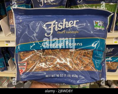 Augusta, Ga USA - 04 15 22: Hand holding Fisher chopped pecans Stock Photo