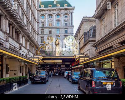 Exterior façade of The Savoy Hotel with illuminated Christmas decorations above the silver canopy. London. Stock Photo